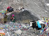 Tibet Kailash 09 Kora 09 Pilgrims on Dolma Rock on Dolma La The actual crossing represents the transition from this life to a new one. Here the pilgrim is reborn and all sins forgiven because of the compassion of D�lma, the Goddess of Mercy. At the pass, pilgrims shout aloud verbal offerings and perform a circumambulation of D�lma�s Rock, pasting money onto the rock with butter, stooping to pass under the lines of prayer flags